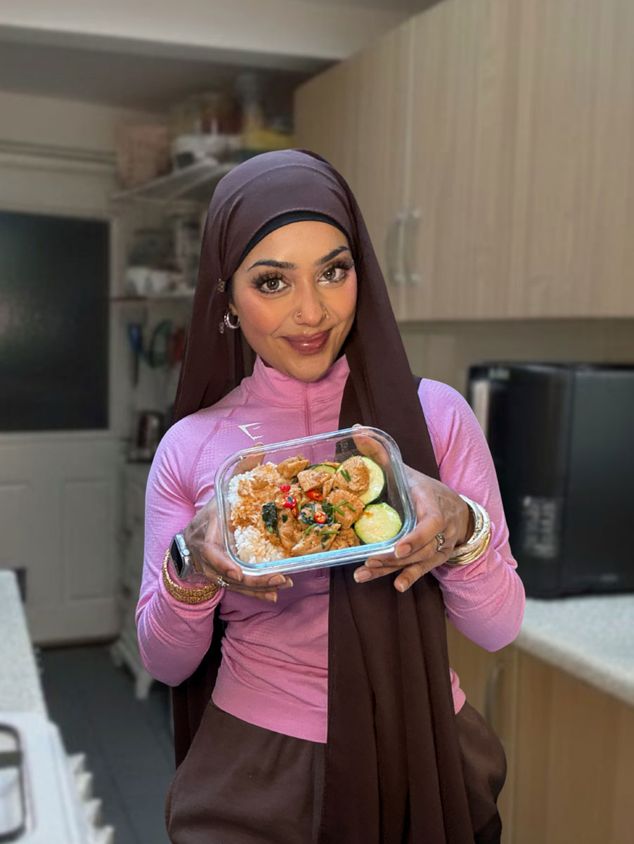Taz holding a home cooked meal prep container